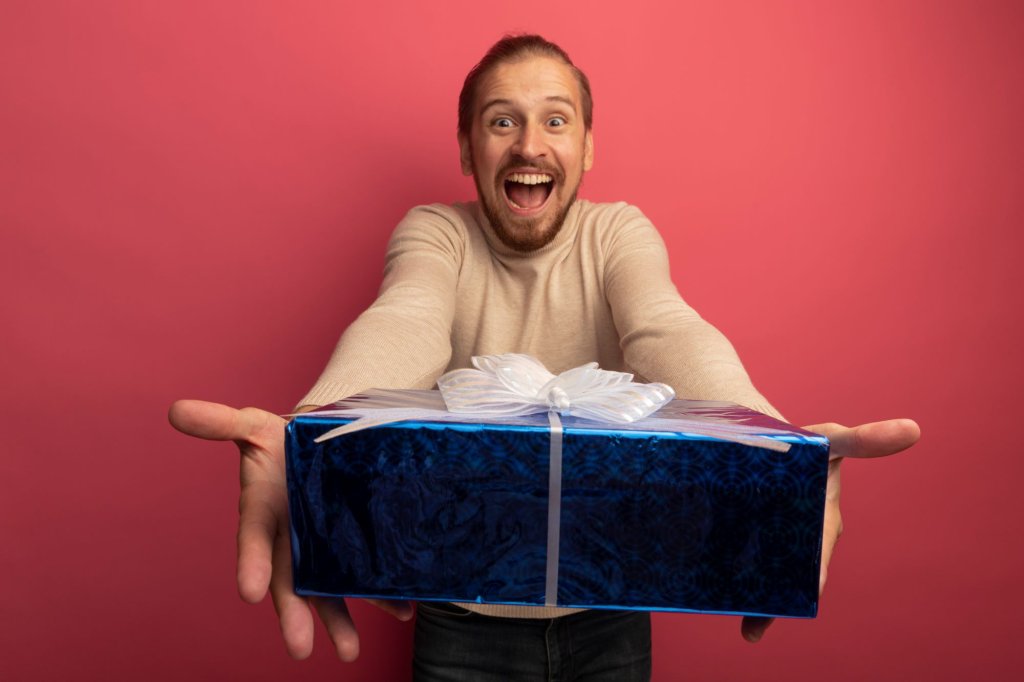 young-handsome-man-beige-turtleneck-showing-gift-box-crazy-happy.jpg