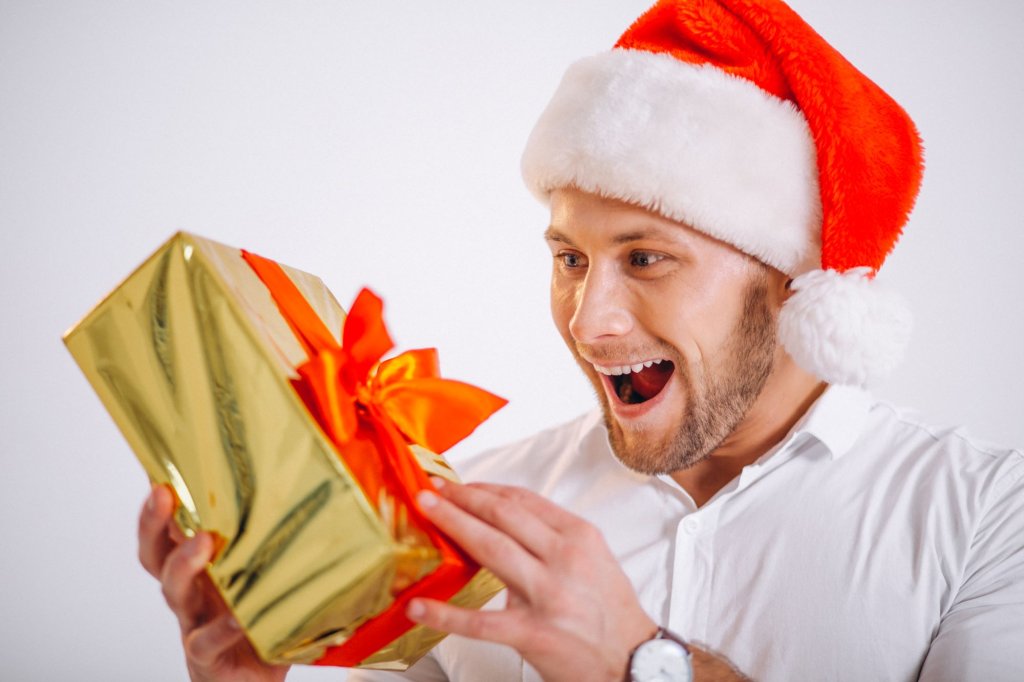 portrait-man-santa-hat-holding-christmas-golden-present-box.jpg