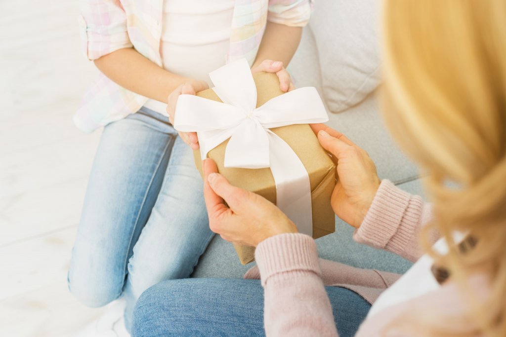 gift-box-in-hands-of-mother-and-daughter (1).jpg