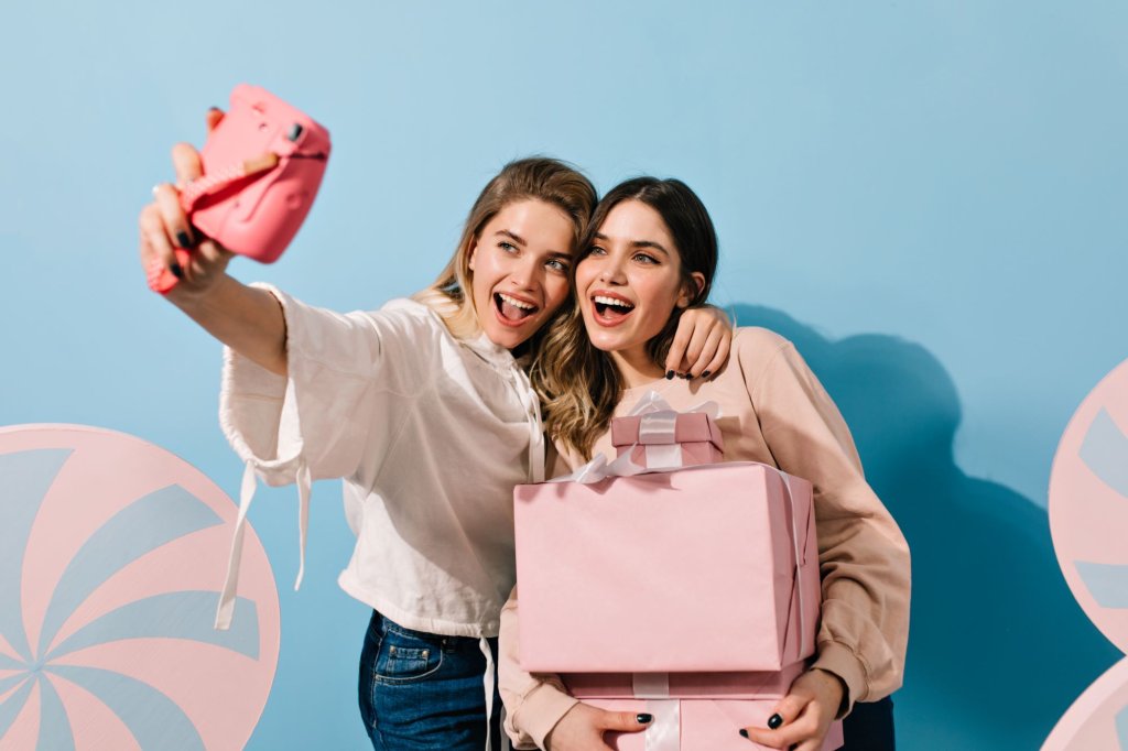 young-ladies-with-pink-camera-taking-selfie.jpg