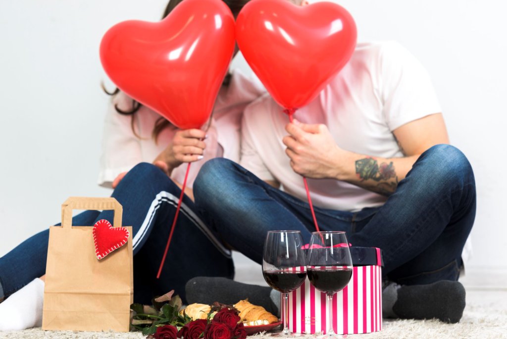 couple-covering-faces-with-red-heart-balloons.jpg