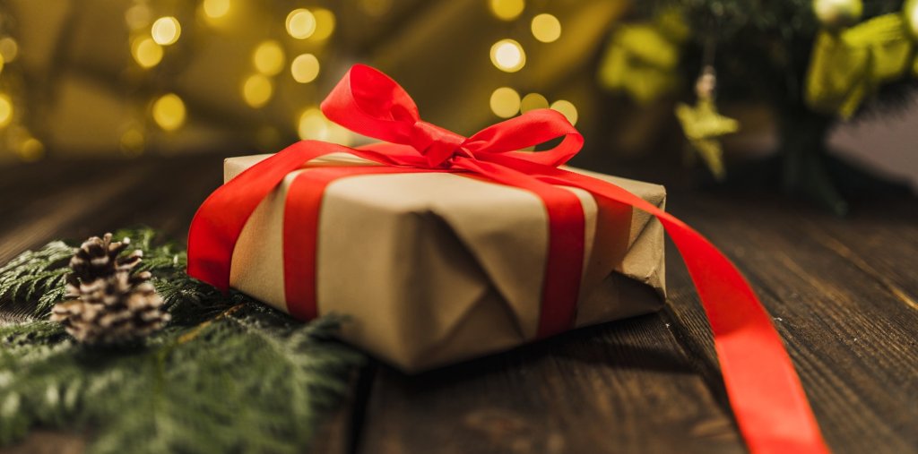 present-box-with-red-bow-near-branch-board.jpg